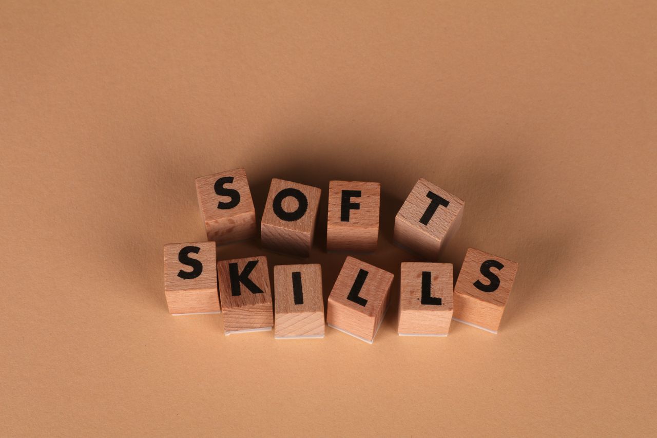 About Wooden letter blocks spell out 'Soft Skills', highlighting business and personal development concepts.